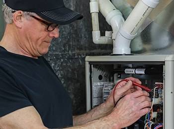 A technician repairing a heating system